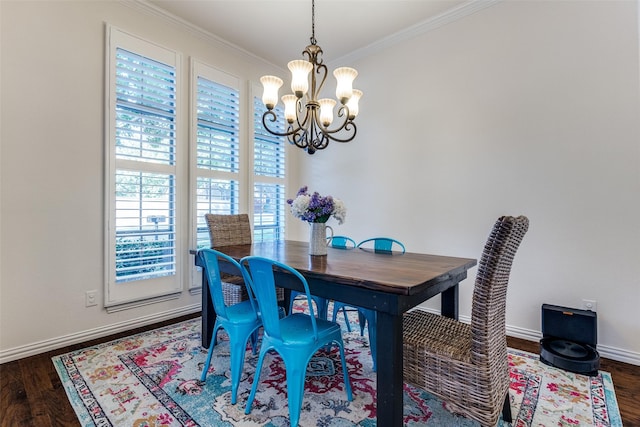 dining room with a chandelier, ornamental molding, dark wood finished floors, and baseboards