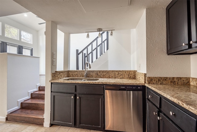 6808 Eastridge Dr Unit A7, Dallas, TX 75231 - kitchen with dishwasher, a sink, light stone countertops, a textured wall, and light wood-type flooring