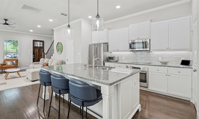 719 Hammond St, Coppell, TX 75019 - kitchen with stainless steel appliances, a sink, open floor plan, recessed lighting, and tasteful backsplash