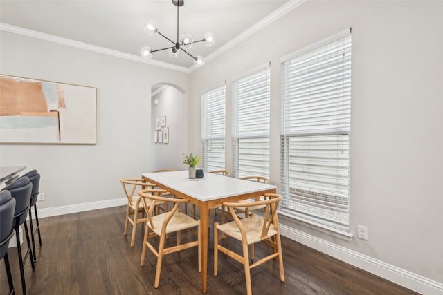719 Hammond St, Coppell, TX 75019 - dining area with arched walkways, ornamental molding, dark wood-type flooring, baseboards, and a chandelier