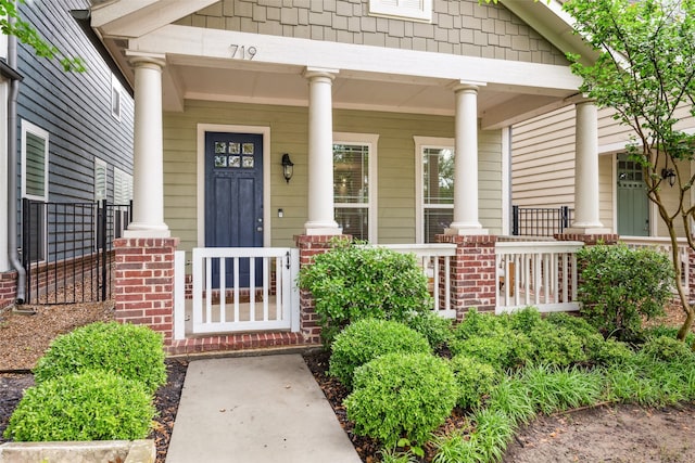 719 Hammond St, Coppell, TX 75019 - property entrance featuring covered porch and brick siding