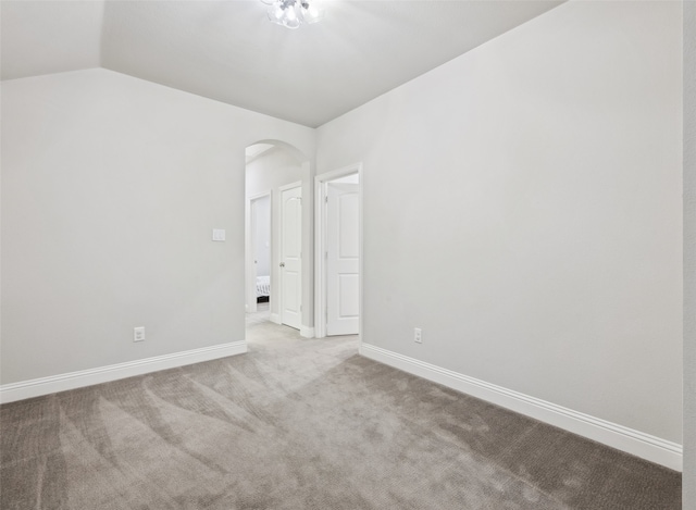 719 Hammond St, Coppell, TX 75019 - carpeted spare room featuring arched walkways, lofted ceiling, and baseboards