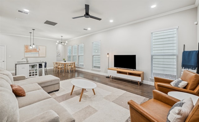 719 Hammond St, Coppell, TX 75019 - living room featuring wood finished floors, a ceiling fan, baseboards, recessed lighting, and crown molding