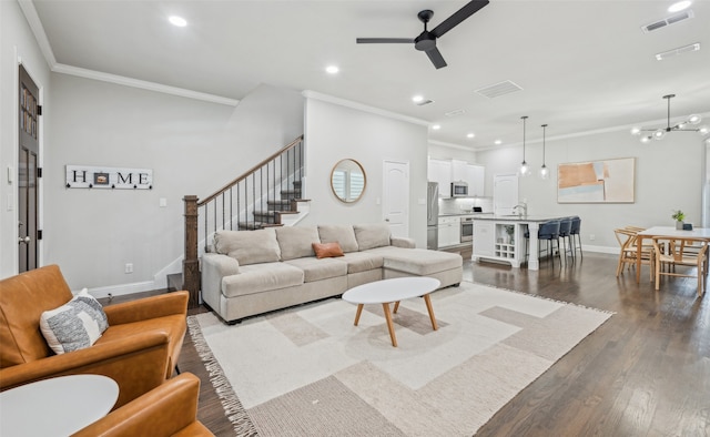 719 Hammond St, Coppell, TX 75019 - living room featuring crown molding, a ceiling fan, dark wood-style flooring, stairway, and recessed lighting