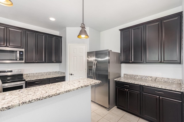 kitchen featuring appliances with stainless steel finishes, light tile patterned floors, hanging light fixtures, light stone counters, and recessed lighting