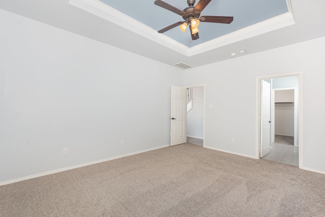 2217 Heaton St, Forney, TX 75126 - unfurnished bedroom with a tray ceiling, light carpet, a walk in closet, baseboards, and a ceiling fan