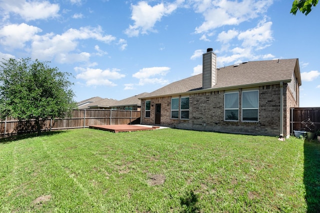 2217 Heaton St, Forney, TX 75126 - back of property with brick siding, a chimney, a shingled roof, and a wooden deck