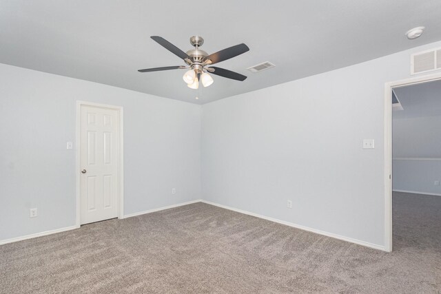 carpeted spare room featuring a ceiling fan, baseboards, and a smoke detector