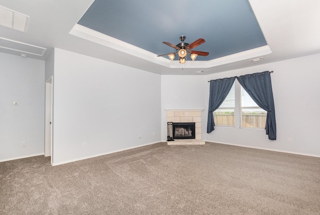 2217 Heaton St, Forney, TX 75126 - unfurnished living room with a tray ceiling, carpet floors, ceiling fan, a stone fireplace, and baseboards