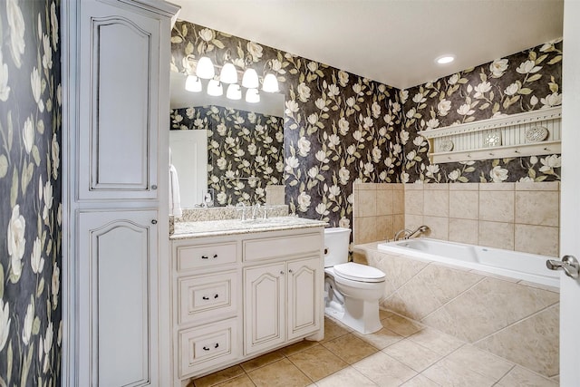 bathroom featuring wallpapered walls, tile patterned floors, a bath, vanity, and toilet