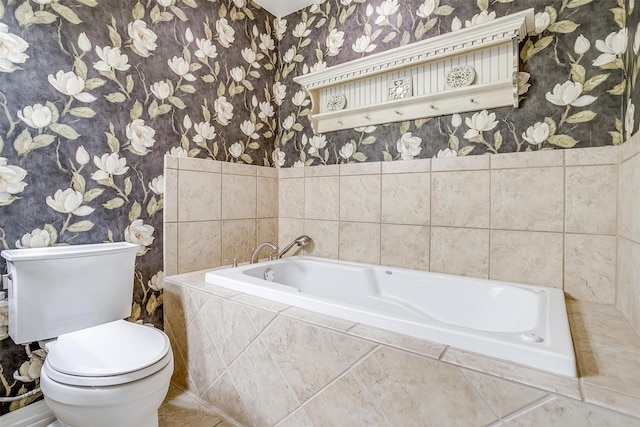 full bathroom featuring wallpapered walls, toilet, and a bath
