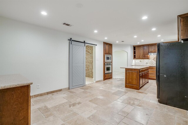 7000 County Road 527, Burleson, TX 76028 - kitchen with stainless steel appliances, open shelves, a barn door, arched walkways, and backsplash