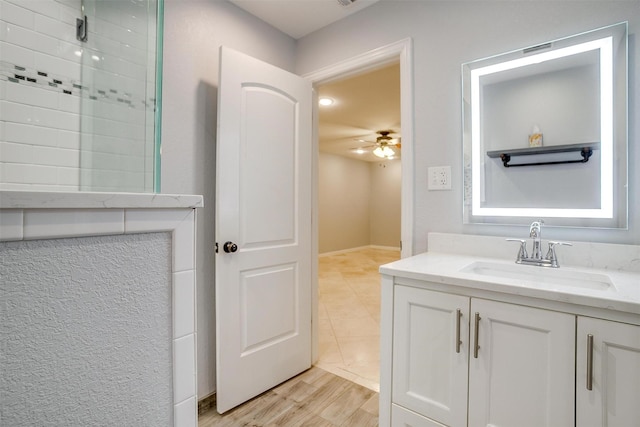 7000 County Road 527, Burleson, TX 76028 - bathroom featuring a ceiling fan, vanity, tiled shower, and wood finished floors