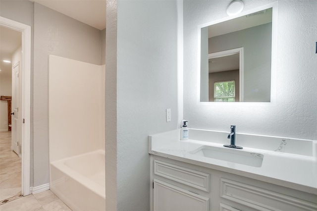 7000 County Road 527, Burleson, TX 76028 - full bathroom featuring tile patterned floors, vanity, and a textured wall