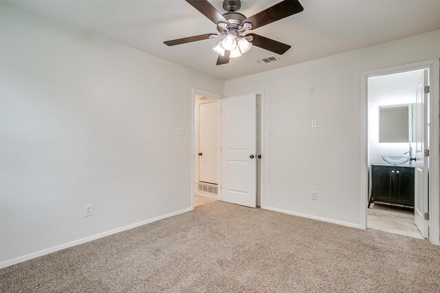 7000 County Road 527, Burleson, TX 76028 - unfurnished bedroom featuring light carpet, baseboards, ensuite bath, and a ceiling fan