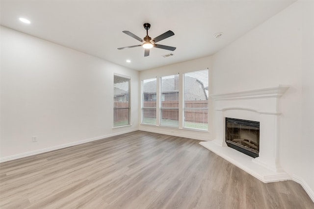 10832 Hawks Landing Rd, Fort Worth, TX 76052 - unfurnished living room featuring ceiling fan, wood finished floors, a fireplace with raised hearth, recessed lighting, and baseboards