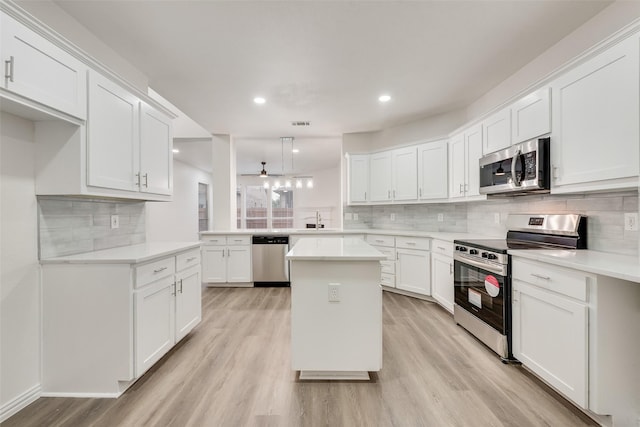 10832 Hawks Landing Rd, Fort Worth, TX 76052 - kitchen with stainless steel appliances, light wood finished floors, decorative backsplash, a sink, and white cabinetry
