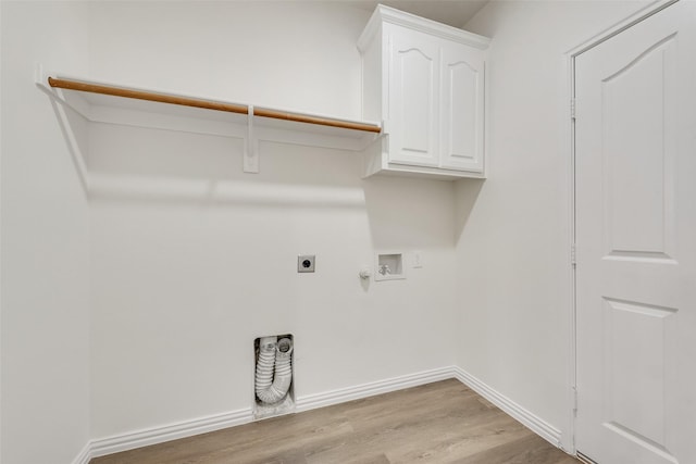 10832 Hawks Landing Rd, Fort Worth, TX 76052 - laundry room featuring electric dryer hookup, washer hookup, light wood-style floors, cabinet space, and gas dryer hookup