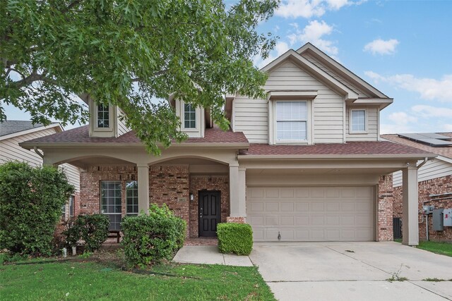 10832 Hawks Landing Rd, Fort Worth, TX 76052 - view of front facade featuring an attached garage, brick siding, concrete driveway, roof with shingles, and a porch