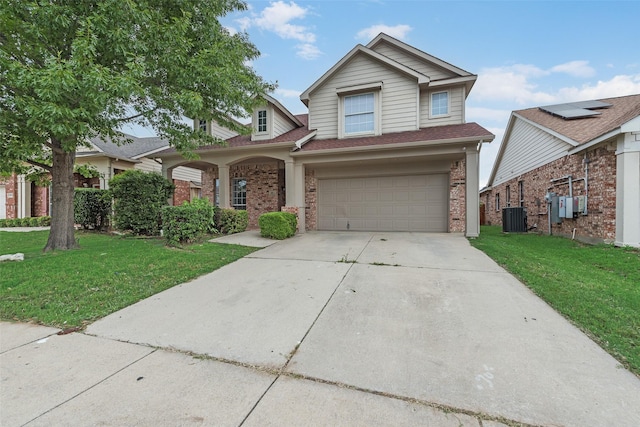 10832 Hawks Landing Rd, Fort Worth, TX 76052 - traditional-style house with a garage, brick siding, a front yard, and central air condition unit