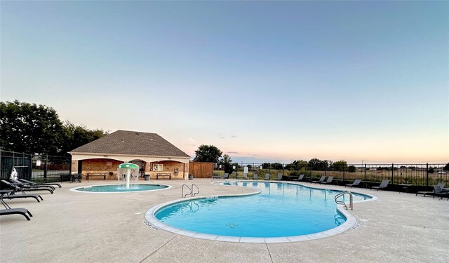 10832 Hawks Landing Rd, Fort Worth, TX 76052 - pool at dusk featuring fence, a community pool, and a patio area