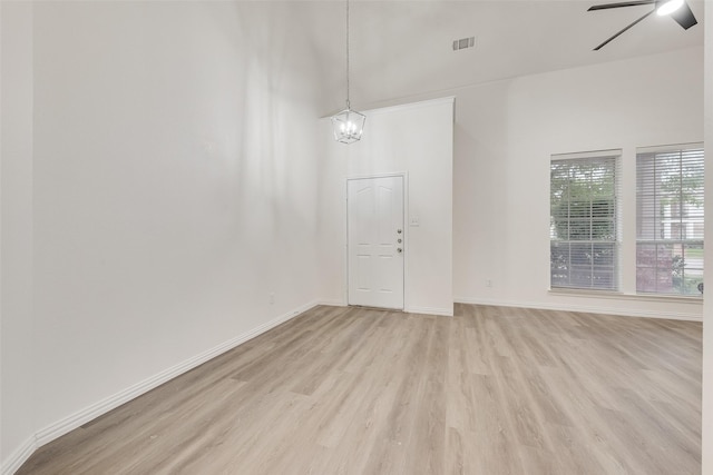 10832 Hawks Landing Rd, Fort Worth, TX 76052 - spare room featuring light wood-style floors, ceiling fan, baseboards, and a chandelier
