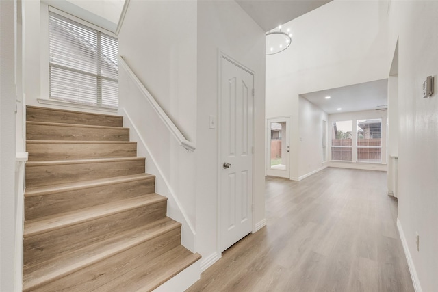 10832 Hawks Landing Rd, Fort Worth, TX 76052 - stairs featuring baseboards, wood finished floors, and a high ceiling