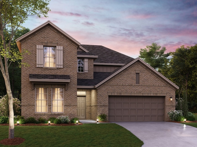 traditional-style home with brick siding, concrete driveway, an attached garage, and a yard