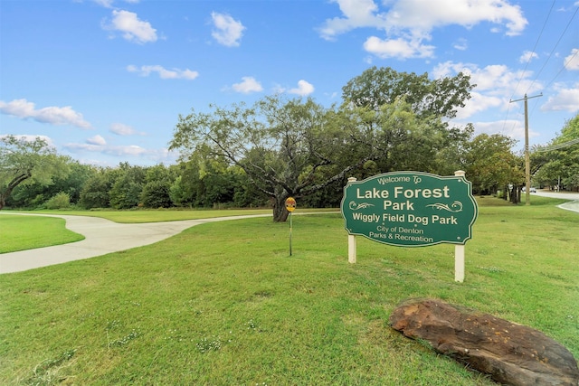 surrounding community featuring a yard and view of scattered trees