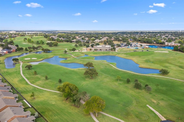 drone / aerial view with a water view, golf course view, and a residential view
