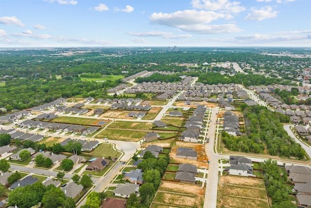 aerial view of property and surrounding area featuring nearby suburban area