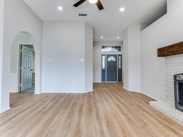 unfurnished living room with a ceiling fan, light wood-style flooring, a fireplace, and recessed lighting