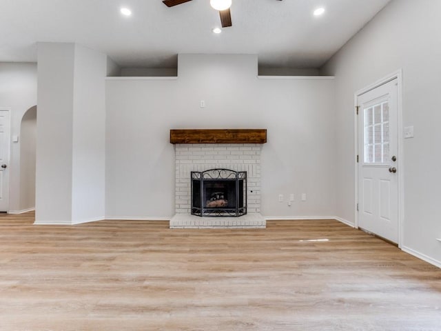 unfurnished living room with wood finished floors, a ceiling fan, recessed lighting, baseboards, and a fireplace