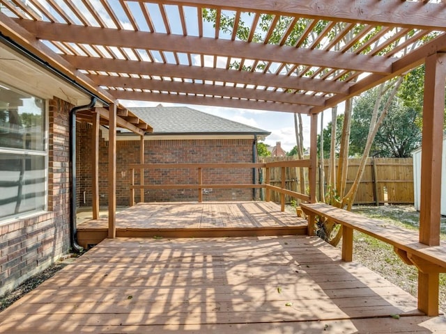 wooden deck with a fenced backyard and a pergola