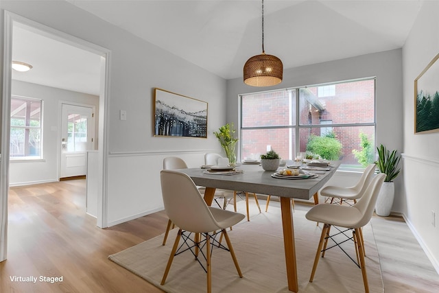 dining room with light wood-style floors and plenty of natural light
