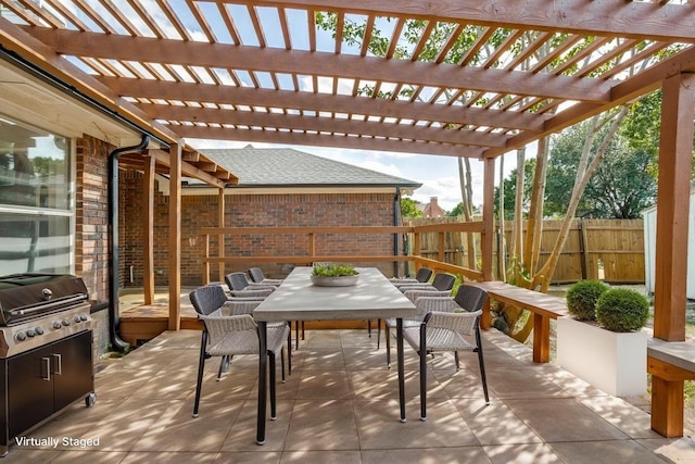 view of patio featuring a fenced backyard, outdoor dining space, a grill, and a pergola