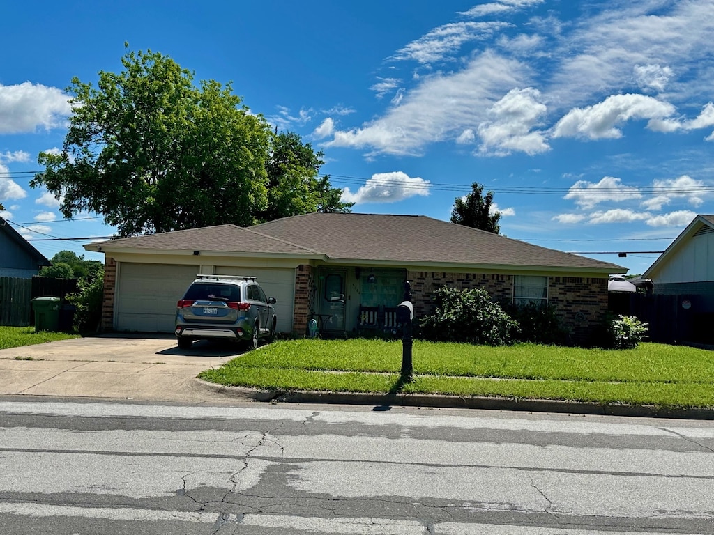 single story home with driveway and a garage