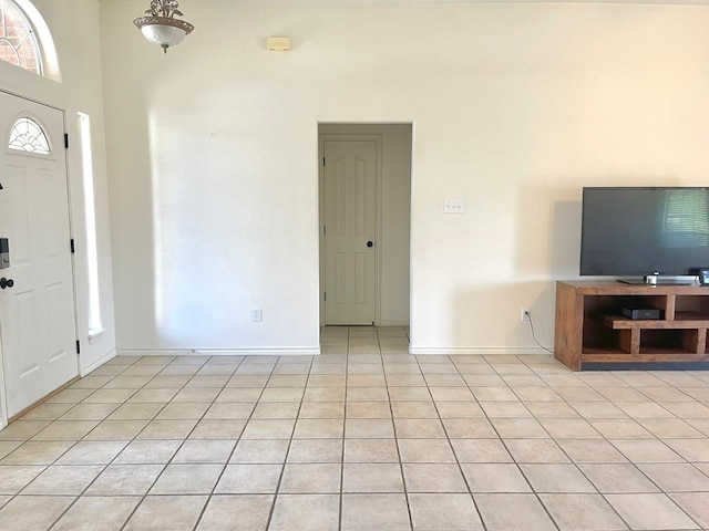 entryway with light tile patterned floors and baseboards