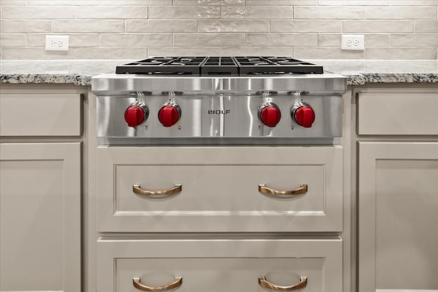 8325 Western, The Colony, TX 75056 - kitchen view of backsplash, light stone countertops, and stainless steel gas cooktop