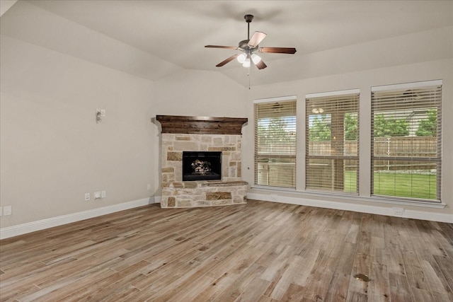8325 Western, The Colony, TX 75056 - unfurnished living room with wood finished floors, ceiling fan, lofted ceiling, baseboards, and a fireplace