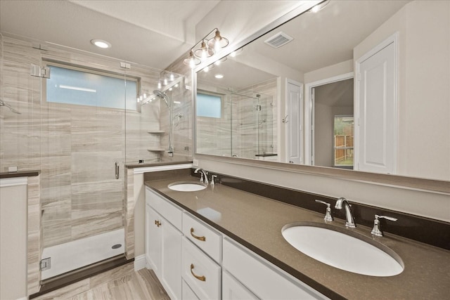 8325 Western, The Colony, TX 75056 - full bathroom featuring a shower stall, double vanity, and recessed lighting