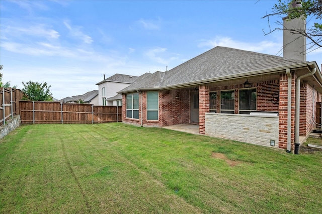 8325 Western, The Colony, TX 75056 - back of house featuring a chimney, a shingled roof, brick siding, and a patio area