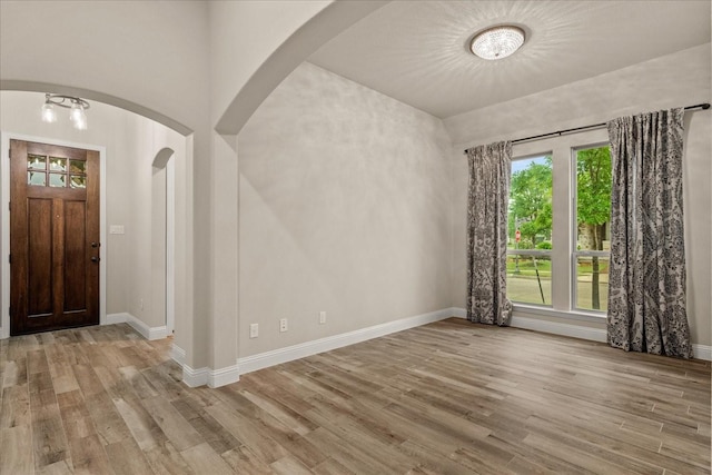 8325 Western, The Colony, TX 75056 - foyer featuring wood finished floors, healthy amount of natural light, arched walkways, and baseboards