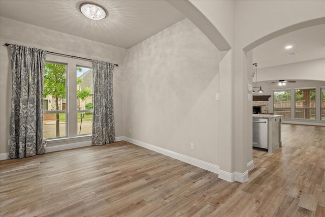8325 Western, The Colony, TX 75056 - unfurnished room with arched walkways, light wood-type flooring, and a ceiling fan
