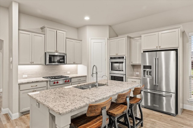 8325 Western, The Colony, TX 75056 - kitchen with stainless steel appliances, a sink, light wood-style flooring, decorative backsplash, and recessed lighting