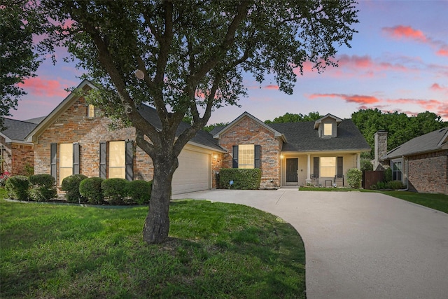 6008 Creekway Dr, Denton, TX 76226 - traditional-style home featuring driveway, a garage, a lawn, and brick siding