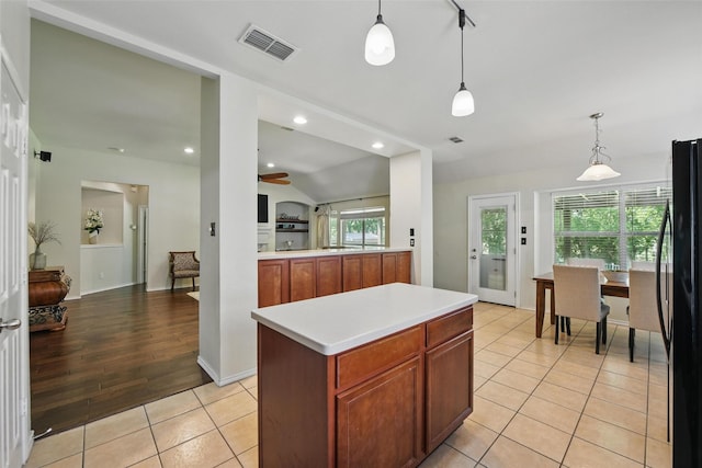 6008 Creekway Dr, Denton, TX 76226 - kitchen featuring freestanding refrigerator, light tile patterned floors, light countertops, lofted ceiling, and hanging light fixtures