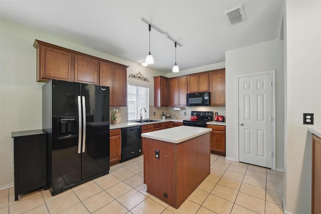 6008 Creekway Dr, Denton, TX 76226 - kitchen featuring black appliances, a sink, tasteful backsplash, and a center island