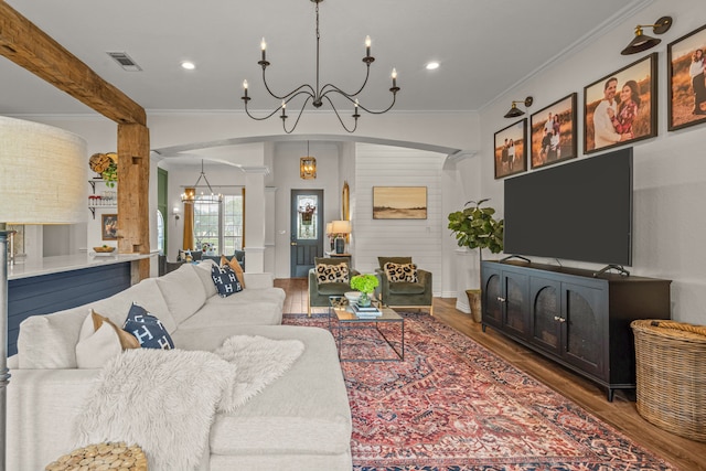 147 Rim Rock Rd, Aledo, TX 76008 - living area with a chandelier, arched walkways, ornate columns, wood finished floors, and crown molding
