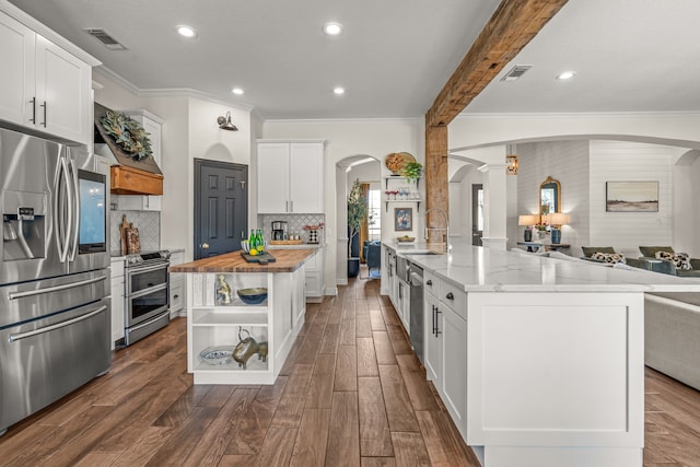 147 Rim Rock Rd, Aledo, TX 76008 - kitchen featuring appliances with stainless steel finishes, wood counters, arched walkways, open shelves, and a sink
